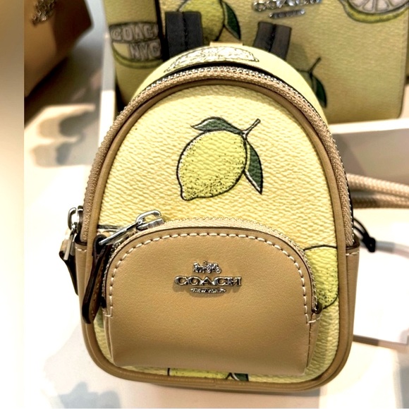 Coach Handbags - NWT Coach Mini backpack keychain Cream and Yellow Lemon Print SOLD OUT